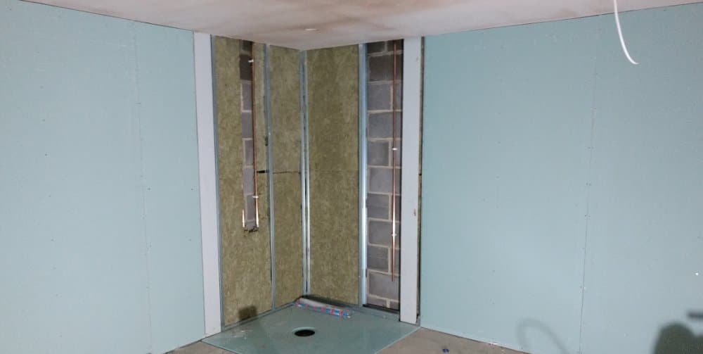 The float room walls are boarded and the shower tray is in place