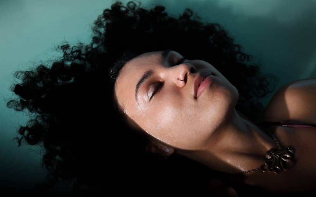 Face of a woman floating blissfully with closed eyes